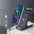 Black wireless charging station with phone, AirPods, and iWatch charging simultaneously on angled stand