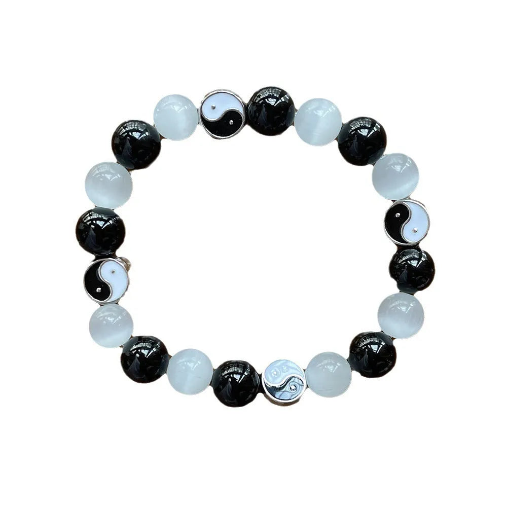 Close-up of a 10mm natural opal and black agate beaded bracelet in a Tai Chi style.