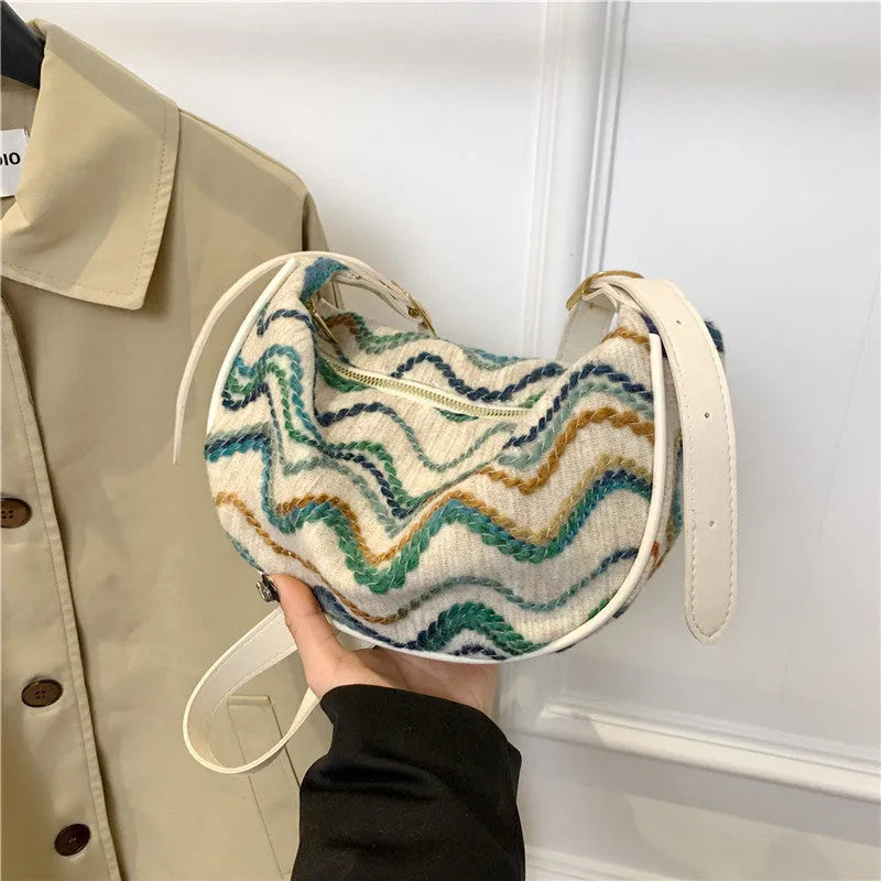 Women's woven straw crossbody bag showing internal phone and file compartments in corrugated brown colour