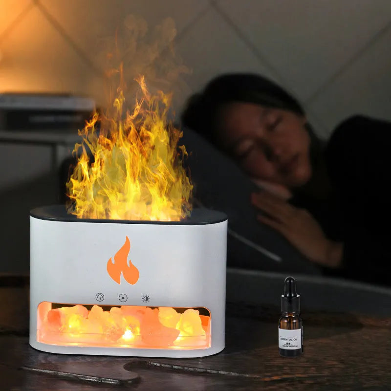 Square white flame effect humidifier and aromatherapy diffuser with coloured 3D light on a desk.