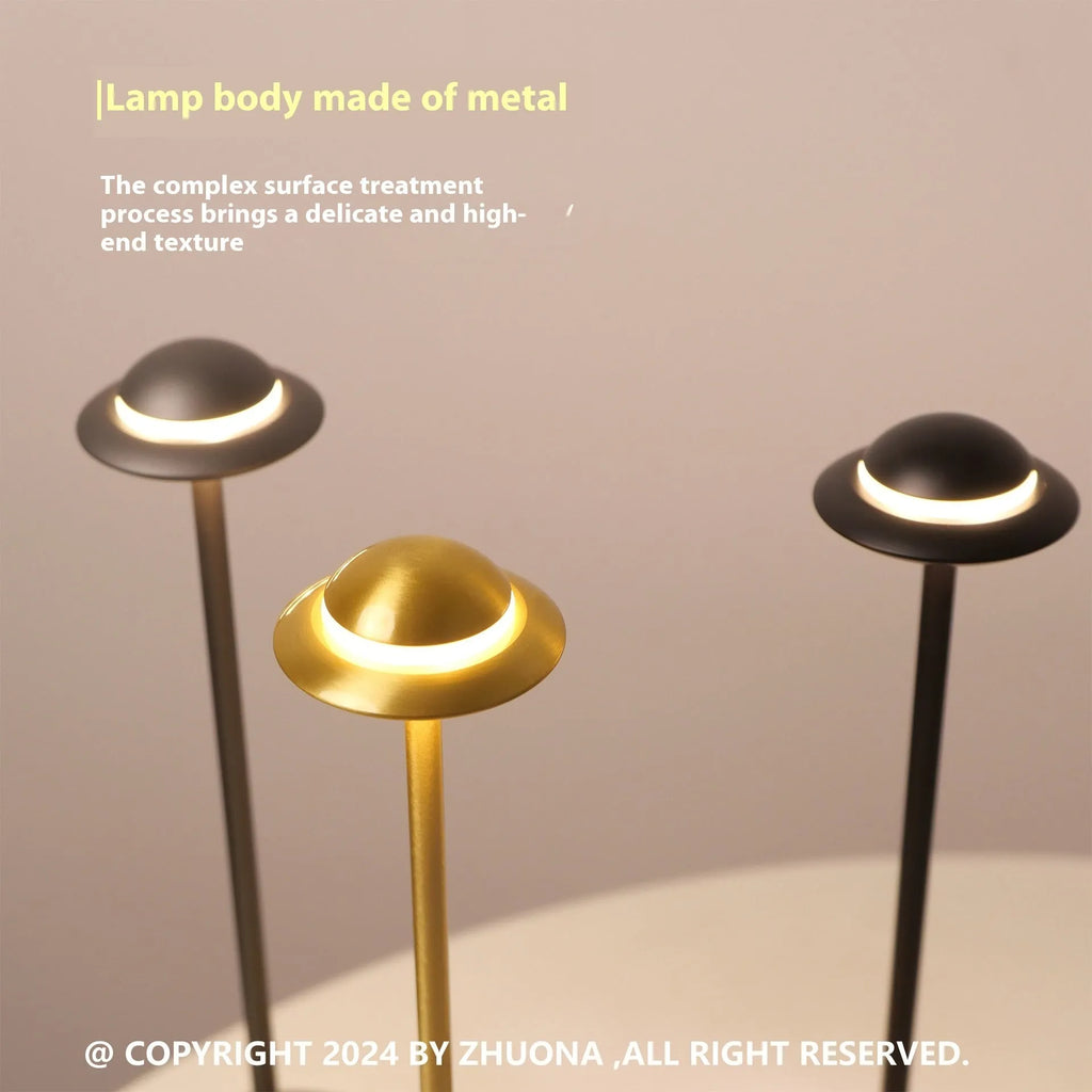 UFO Table Lamp in black with touch dimming panel and rechargeable design on a wooden desk