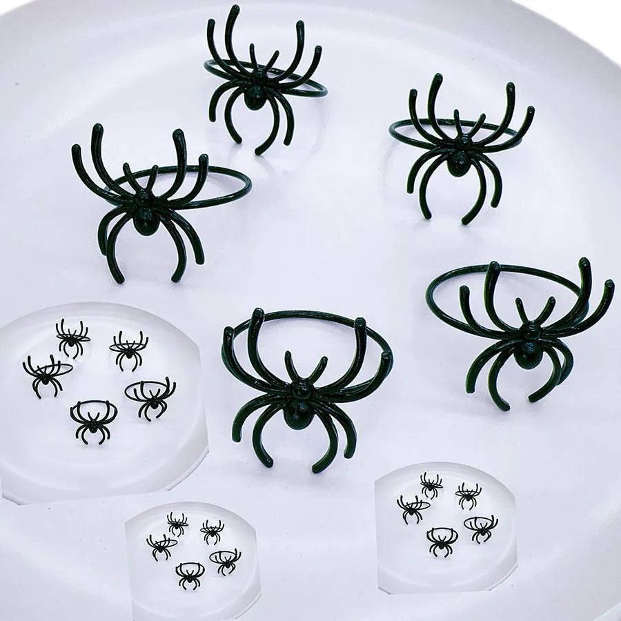 Six black spider-shaped alloy napkin rings for Halloween table decorations with electrophoresis surface finish