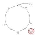 Women's sterling silver anklet with a geometric zirconium pendant on an ankle
