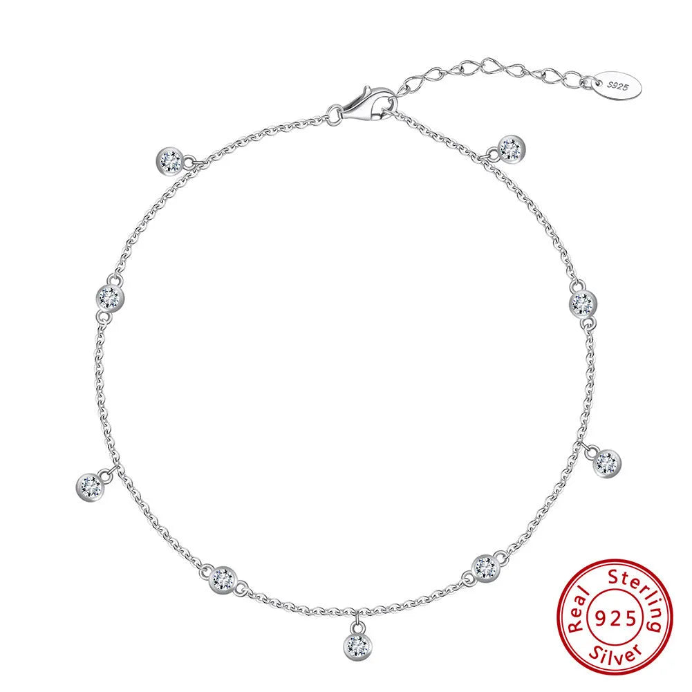 Women's sterling silver anklet with a geometric zirconium pendant on an ankle
