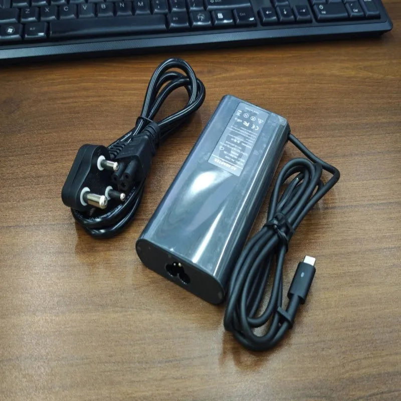 Black 65W USB Type-C laptop power adapter with international travel plug set