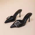 Black women's pointed toe high heels with adjustable ankle strap and decorative buckle fastening