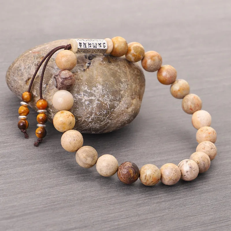 Handmade natural stone bead bracelet in a wood tone colour on a white background.