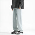 Men's washed light blue straight leg jeans with button waist on a plain background.