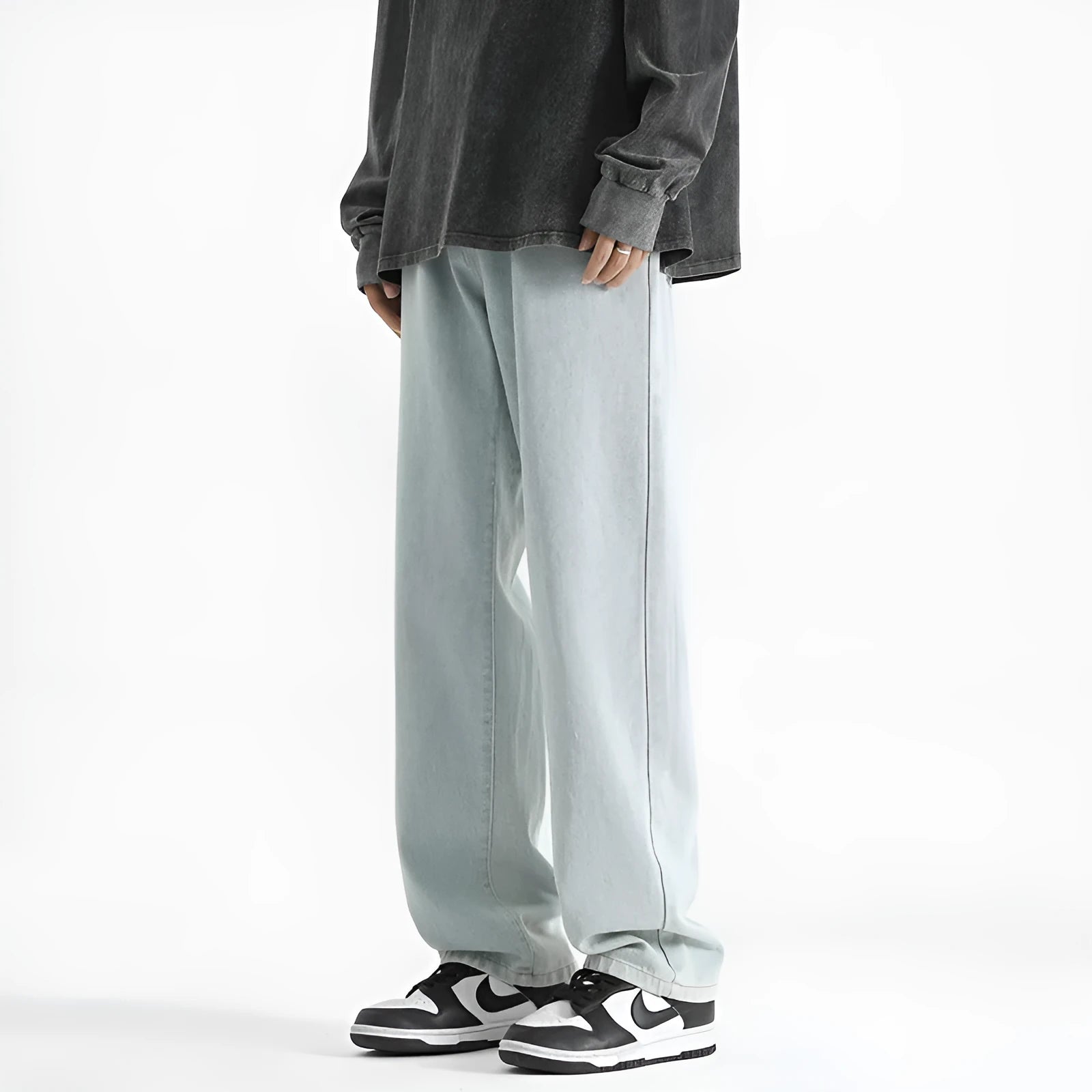 Men's washed light blue straight leg jeans with button waist on a plain background.