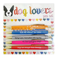 Set of five coloured push-action pens with cat and dog designs next to a beaded storage bag.