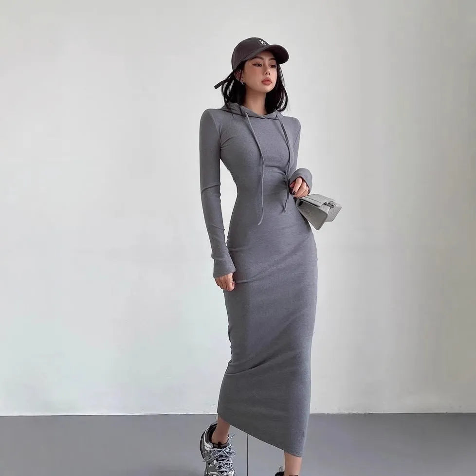Women's grey hooded sheath dress with over-the-knee length and long sleeves showing high waist design