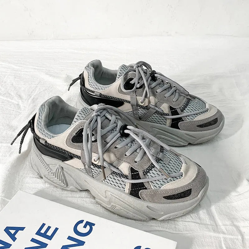 Men's white platform trainers with lace-up front and a breathable mesh lining, shown from the side.
