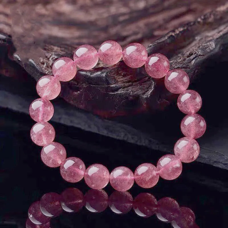 Women's strawberry quartz bracelet with polished crystal beads in 6mm, 8mm, or 10mm sizes on a wrist