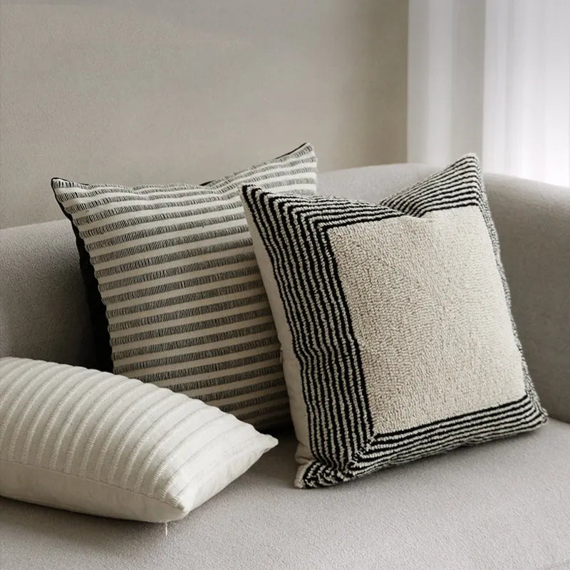 Black and white geometric patterned square and waist living room cushions with towel embroidery.