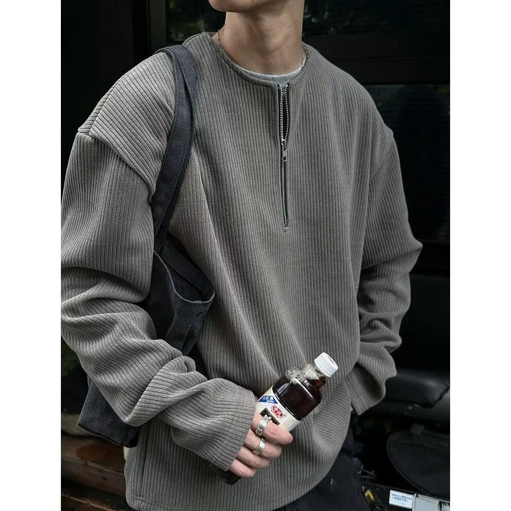 Solid colour loose fit long sleeve pullover top shown in grey, black, or apricot.
