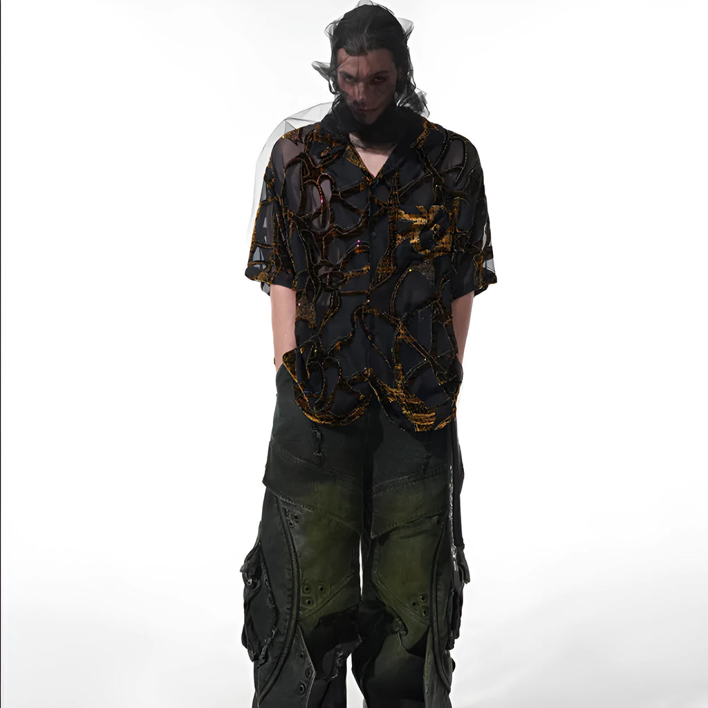 Man wearing a black translucent short-sleeved shirt with a snake pattern, featuring a lapel collar and loose fit.