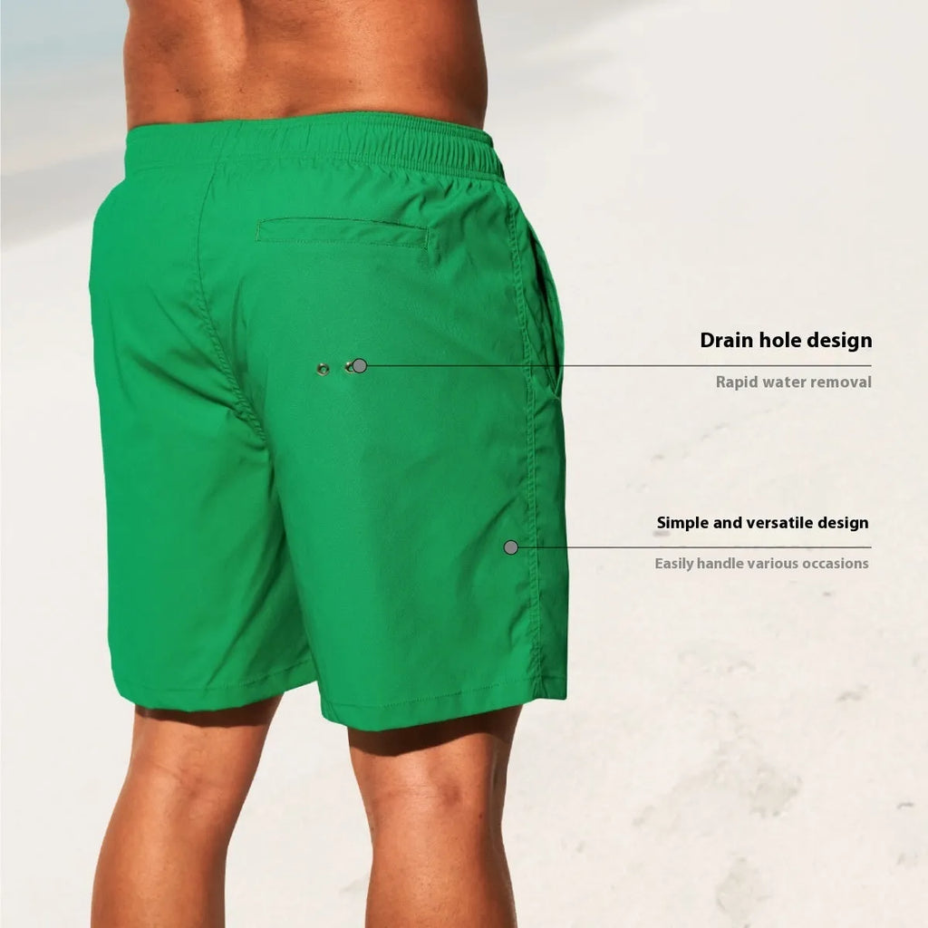 Men's solid colour quick-dry nylon shorts in green, shown with straight leg and elasticated waist.