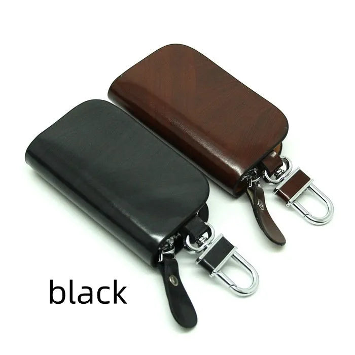 Black or brown genuine leather car key case with zipper, showing soft cowhide texture and internal size of 9.5cm by 4.5cm