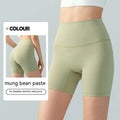 Women's high-waisted lycra yoga shorts in leaf green for fitness.