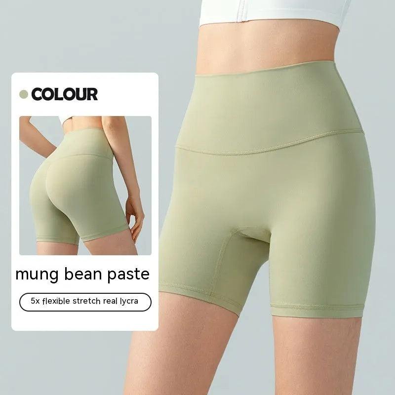 Women's high-waisted lycra yoga shorts in leaf green for fitness.