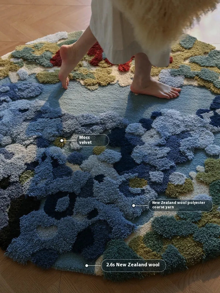 Ocean blue handmade wool round carpet on wooden floor showing tufted texture and circular shape