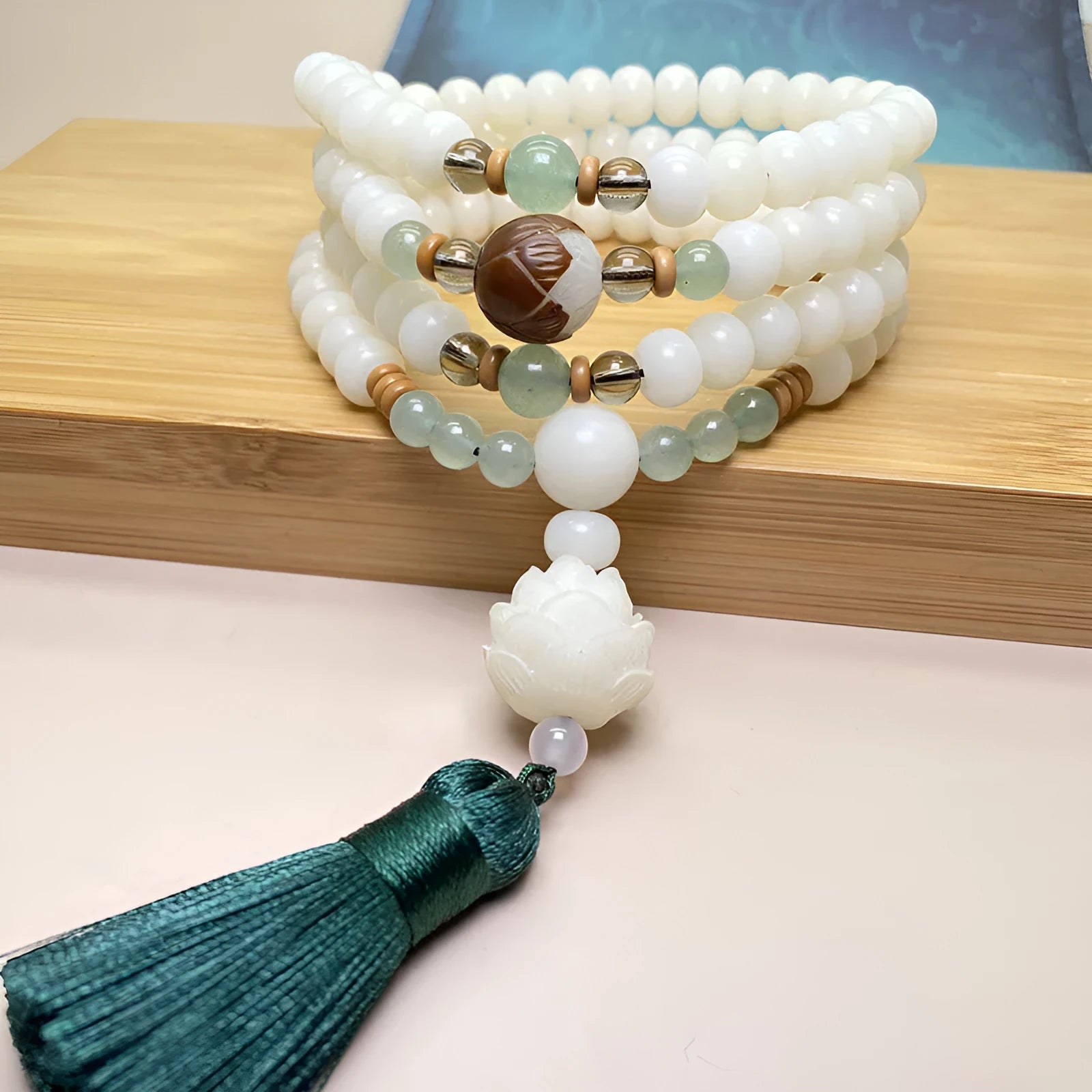 White jade Bodhi stone 108-bead bracelet in three style options with different bead sizes on a wrist.