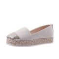 Beige and black canvas shoe covers with round toe design showing oversleeves construction