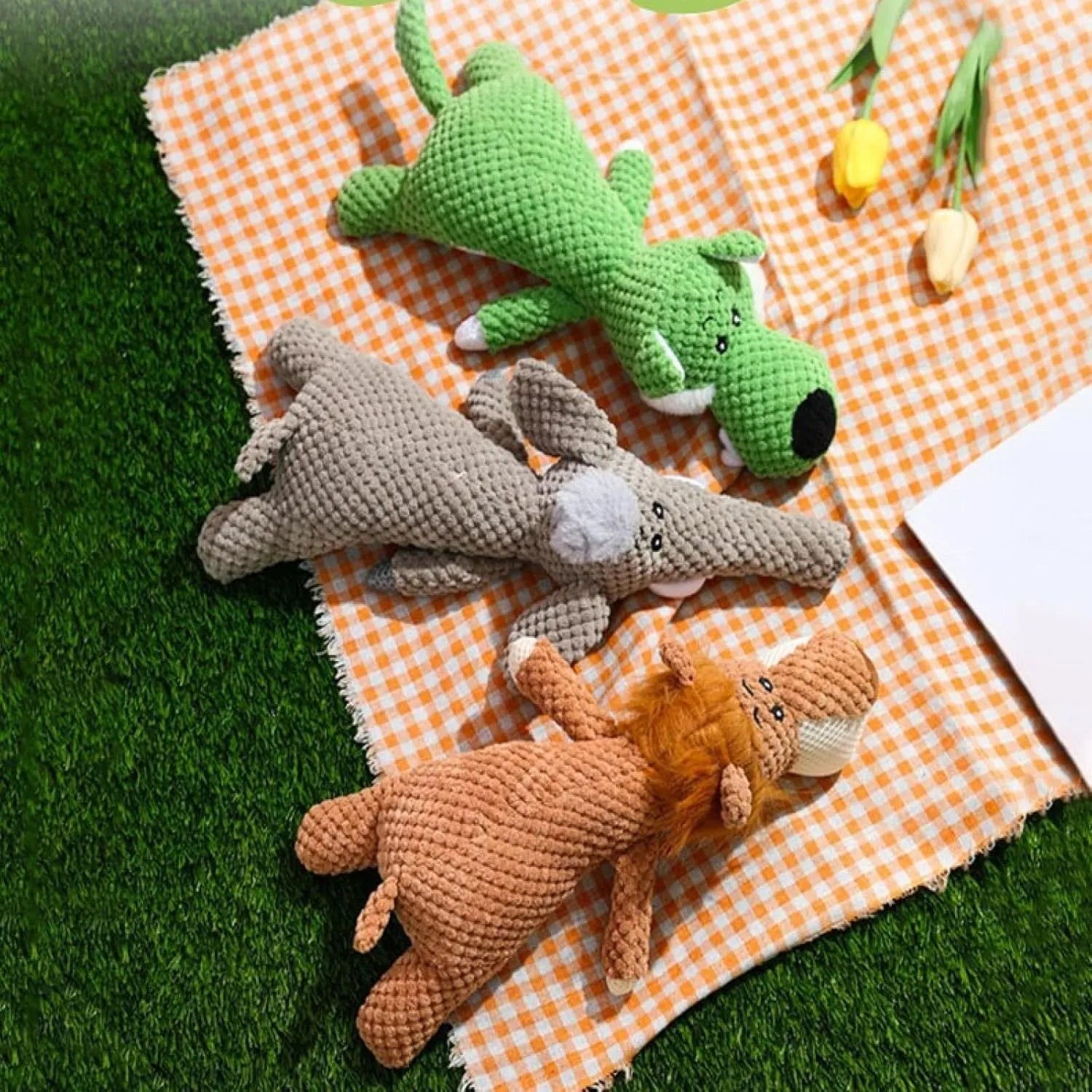 Green plush dog toy with corn kernel texture design for teeth cleaning, featuring squeaker inside