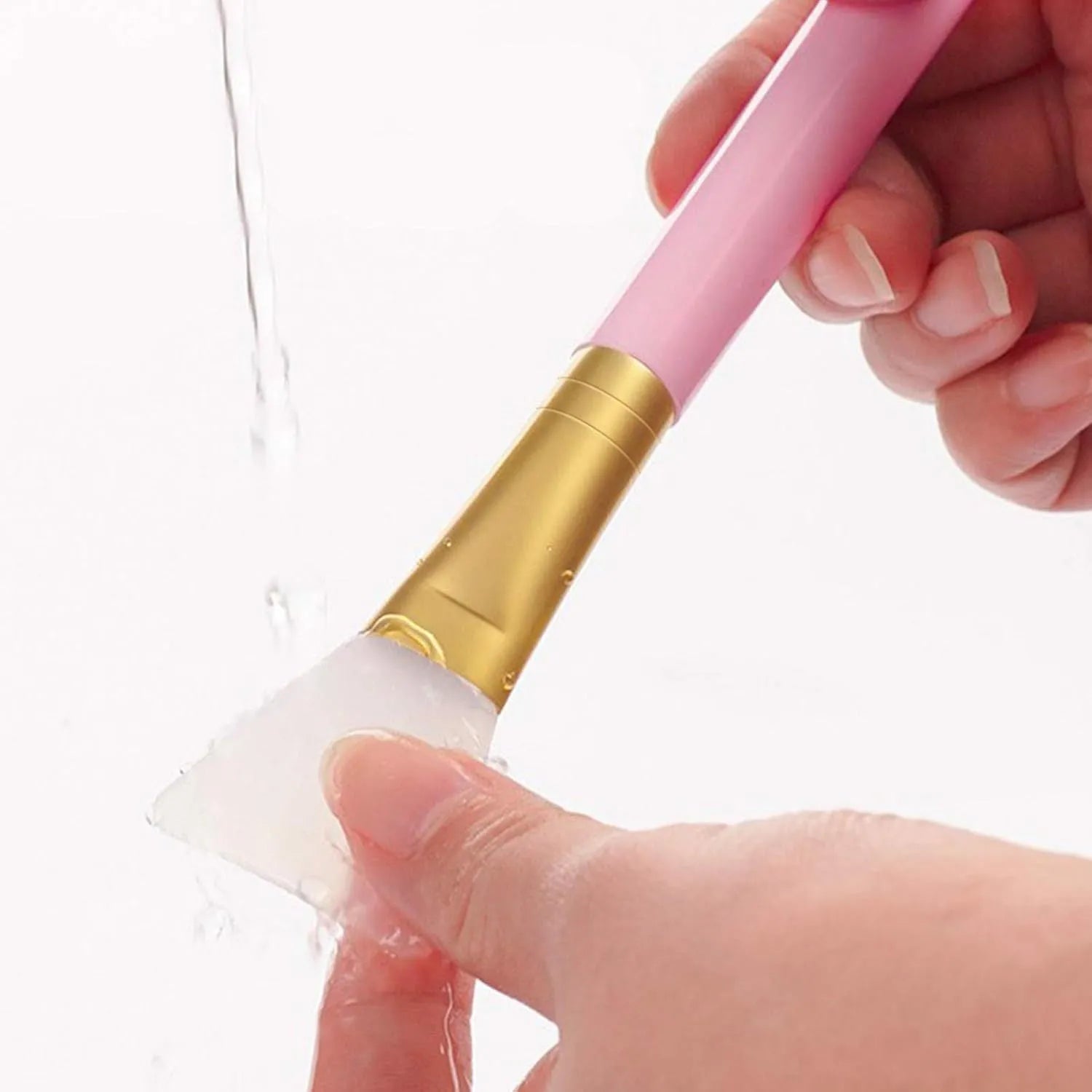 Reusable silicone spatula applicator for face and body masks in various colours on a plain background.