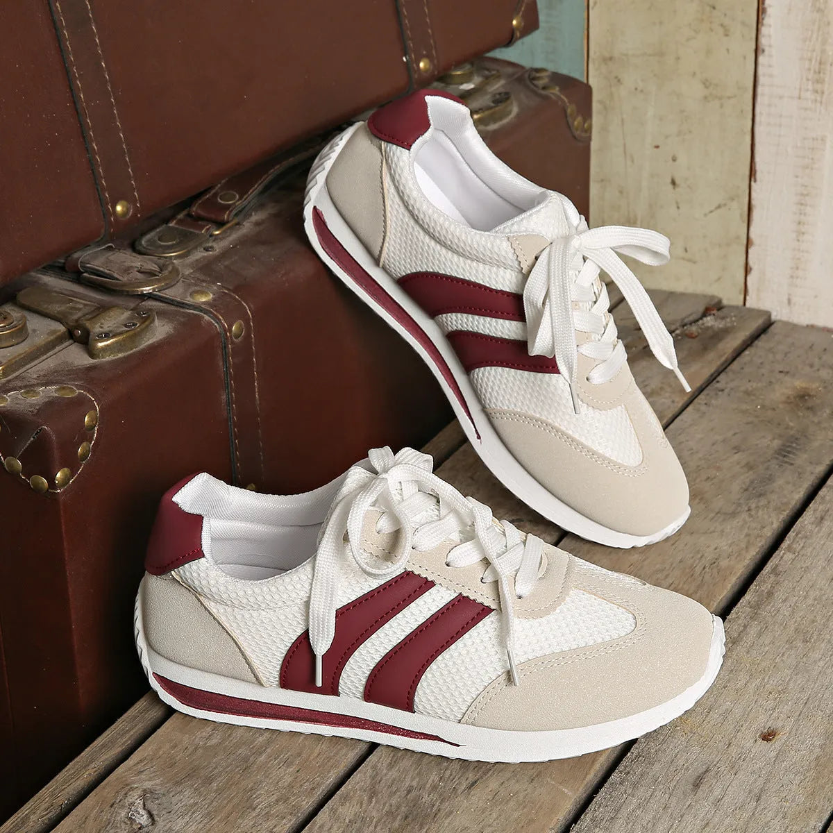 Wine red Cortez Retro low-top sneakers with cross-strap detail on synthetic leather upper.