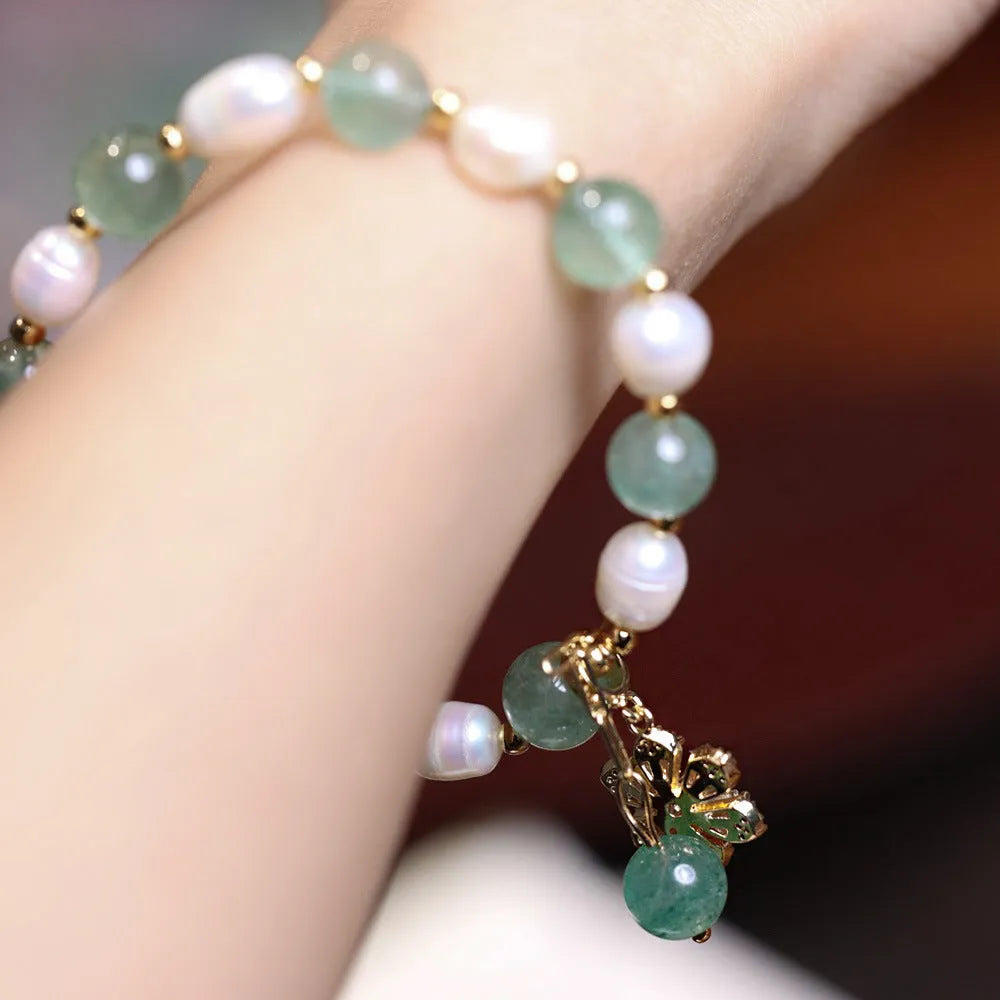 Green strawberry-shaped freshwater pearl bracelet with Chinese knot closure and small flower pendant