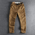 Men's khaki and dark blue cotton work trousers with a 3D cut and zip fly.