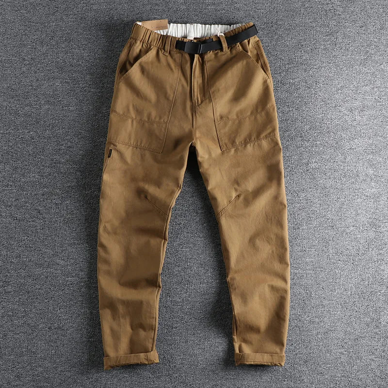Men's khaki and dark blue cotton work trousers with a 3D cut and zip fly.