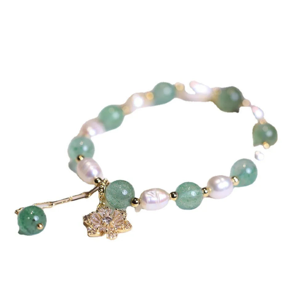 Green strawberry-shaped freshwater pearl bracelet with Chinese knot closure and small flower pendant