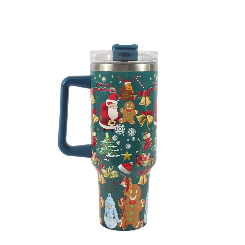 A large stainless steel travel mug with a handle, straw, and Christmas pattern, shown next to its leak-proof lid.