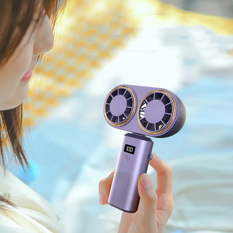 Handheld mini fan with folding neck strap and digital display in milky white colour