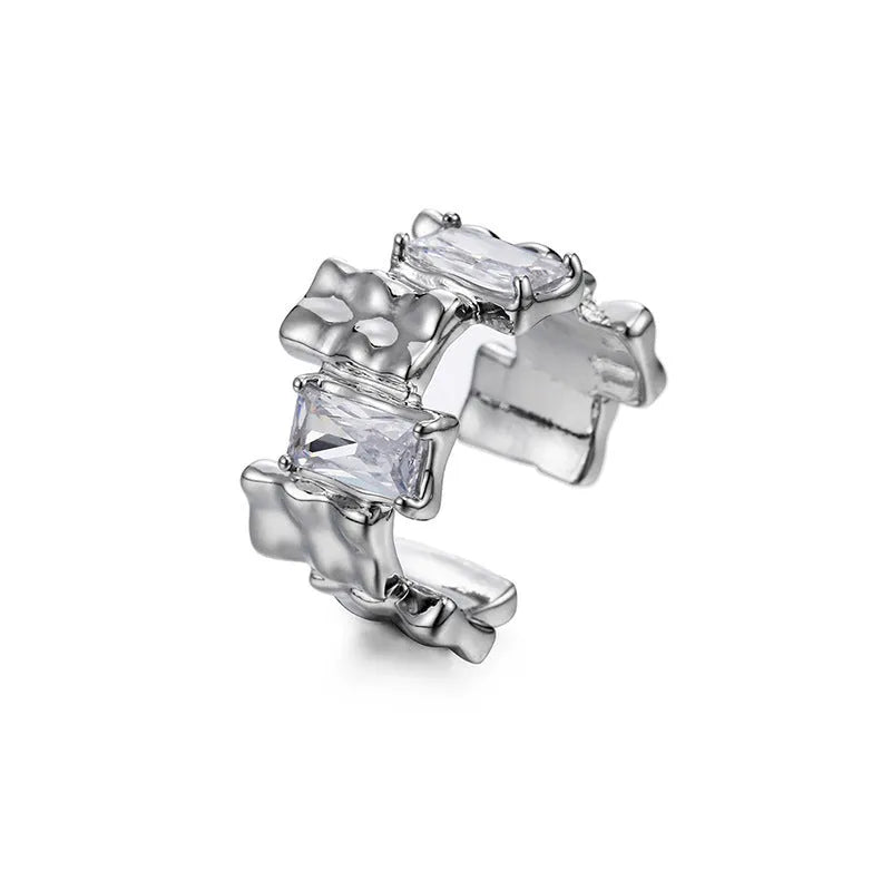 Silver geometric ring with open adjustable band and three-dimensional decoration, shown from multiple angles