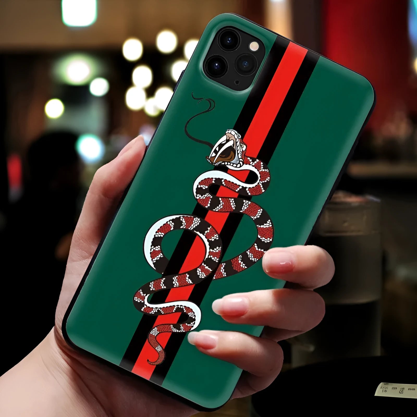 Soft silicone iPhone case with frosted surface showing detailed snake cartoon pattern in black colour