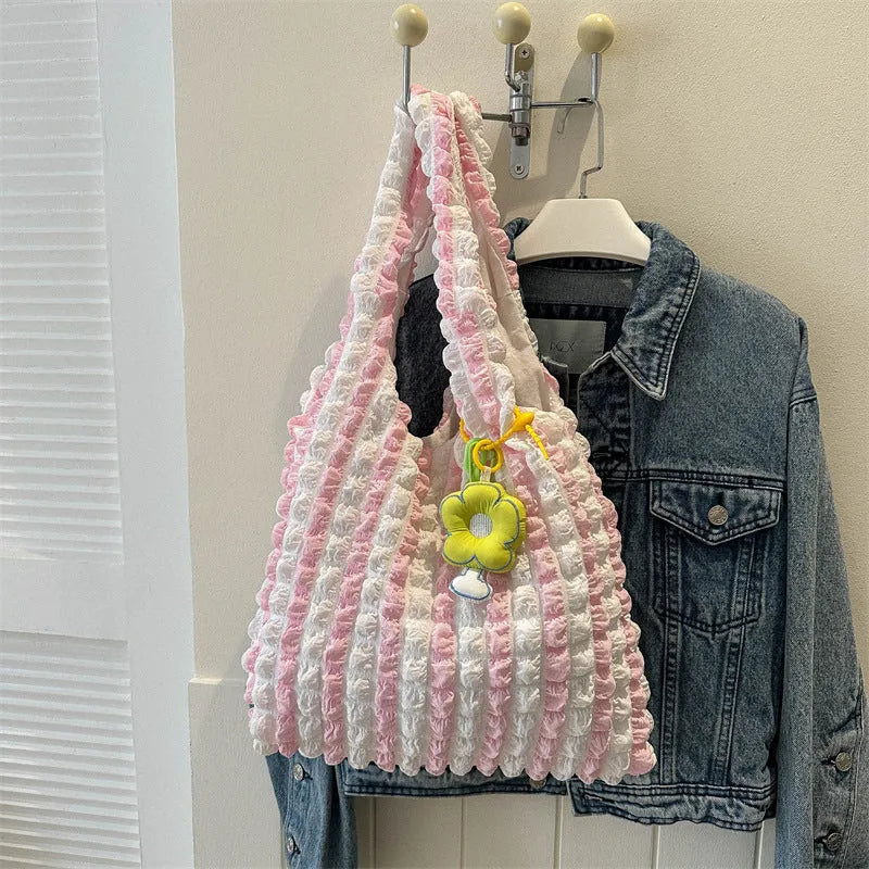 Soft square polyester shoulder bag with pleated bubble texture and an optional pendant, shown in multiple colours.