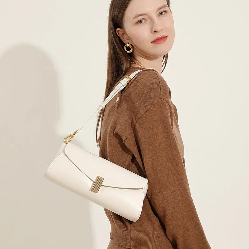 Milky white cowhide leather women's crossbody bag showing clamshell opening and pillow shape.