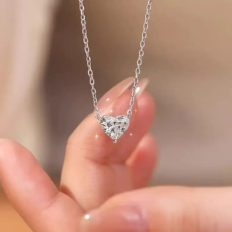 Simple silver-coloured women's necklace with a small love heart pendant on a chain.