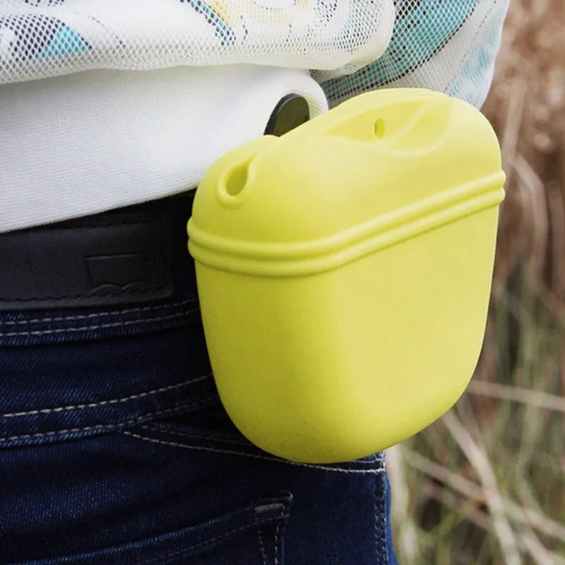 Silicone dog treat bag with magnetic closure measuring 12.5cm long, shown attached to belt with treats visible inside