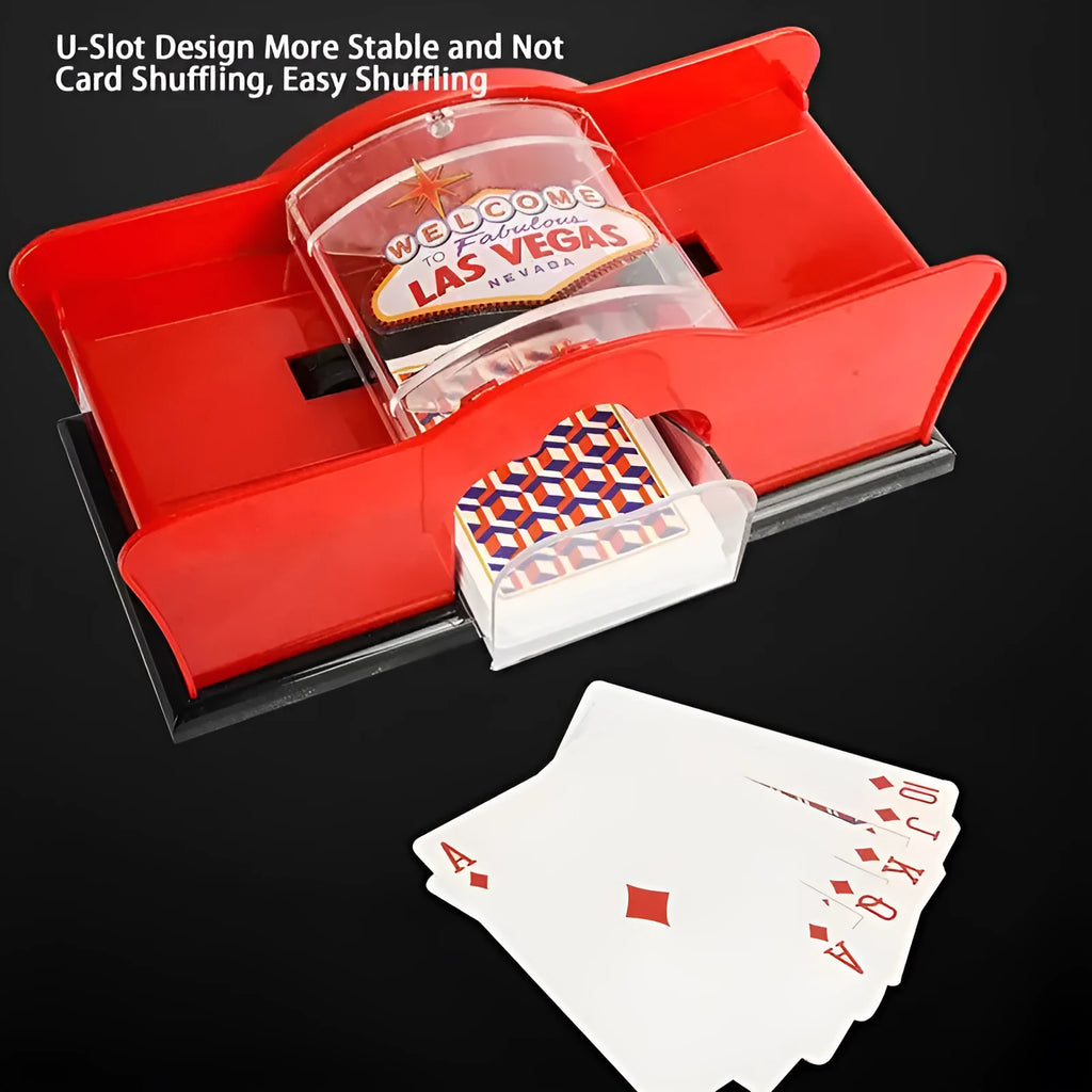 Black manual card shuffler with hand crank on a table next to playing cards.
