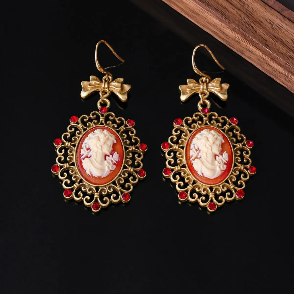 Retro court beauty head alloy drop earrings with bow detail and electroplated finish, one pair
