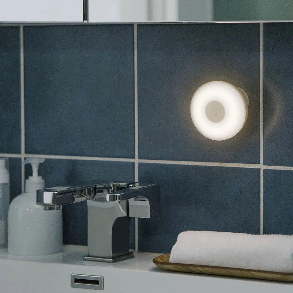 White Mijia Night Light 2 Bluetooth bedside lamp with human body induction, 94mm width, on wooden table