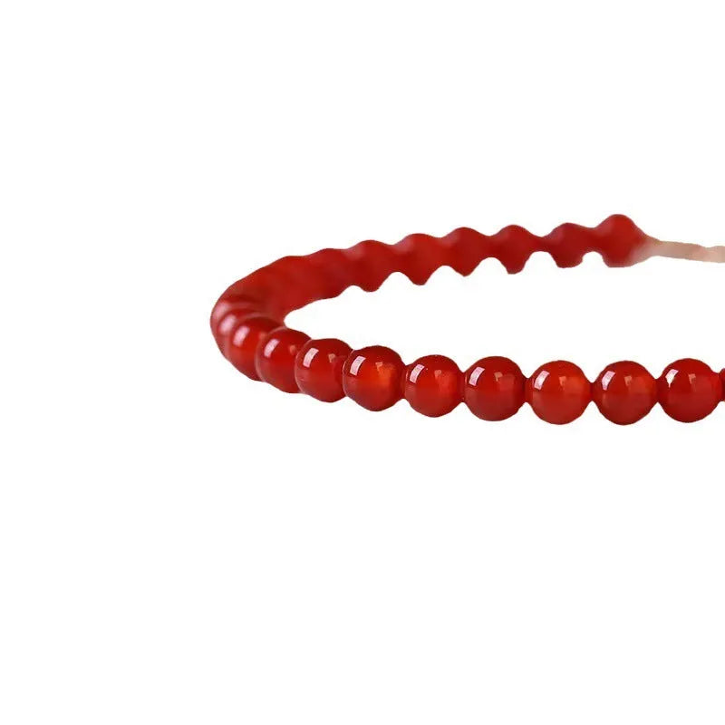 A red agate bracelet for women with an ultra-thin, delicate design on a wrist.