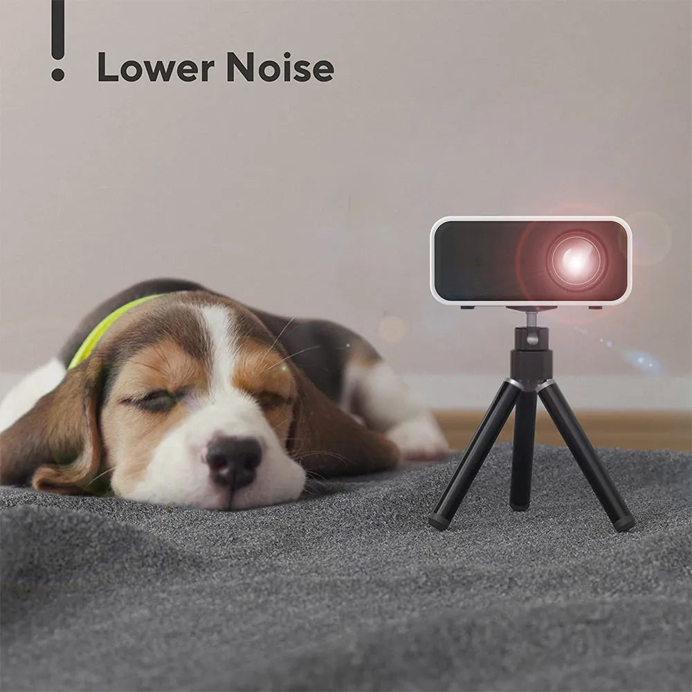 Black YT300 portable mini projector on a table, projecting a movie scene onto a wall.