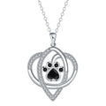 Copper pendant necklace showing cat and dog paw prints on a delicate cross chain.