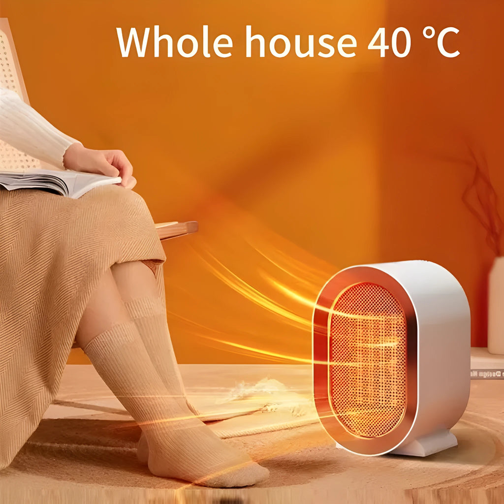 Small black portable ceramic fan heater with UK plug on a wooden desk
