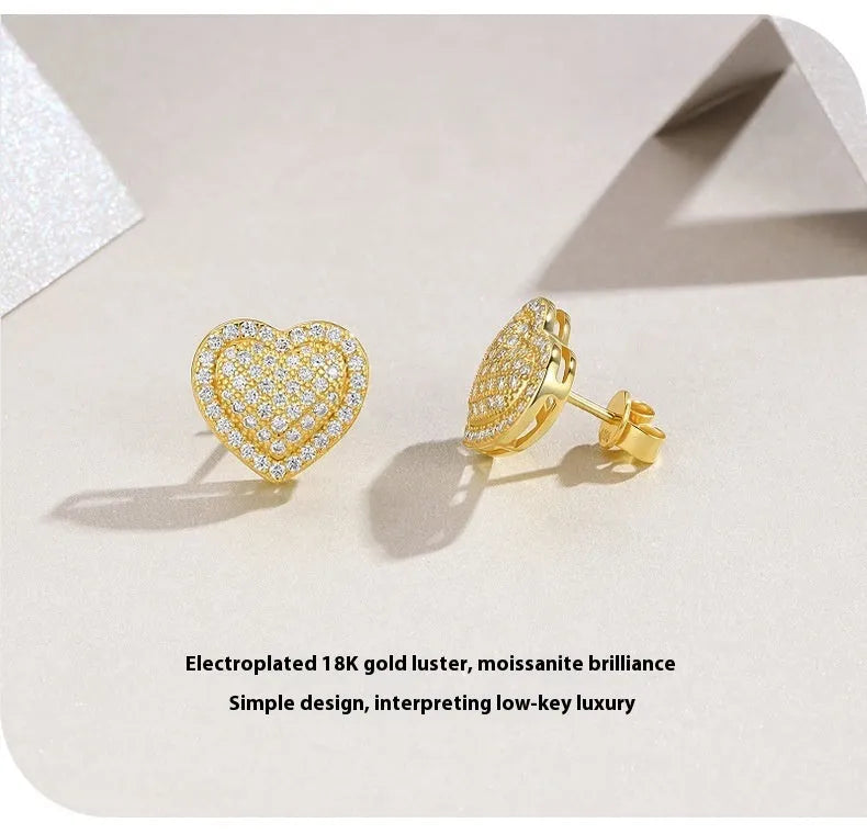 Golden heart-shaped moissanite stud earrings with sterling silver posts and butterfly backs